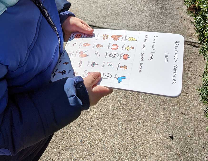 halloween Child holding a handmade Halloween scavenger hunt